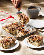 Whole Sour Cream Coffee Cake being served on white plates. So moist and delicious, sour cream coffee cake full of chocolate, walnuts, cinnamon and sugar streusel, with coffee.  This super moist coffee cake is the best coffee cake. Best coffee cake san diego, best coffee cake recipe, best coffee cake ever, sour cream coffee cake, sour cream coffee cake moist and delicious, best cookies san diego, best cookies near me, best cookies la jolla, best cookies carlsbad, 