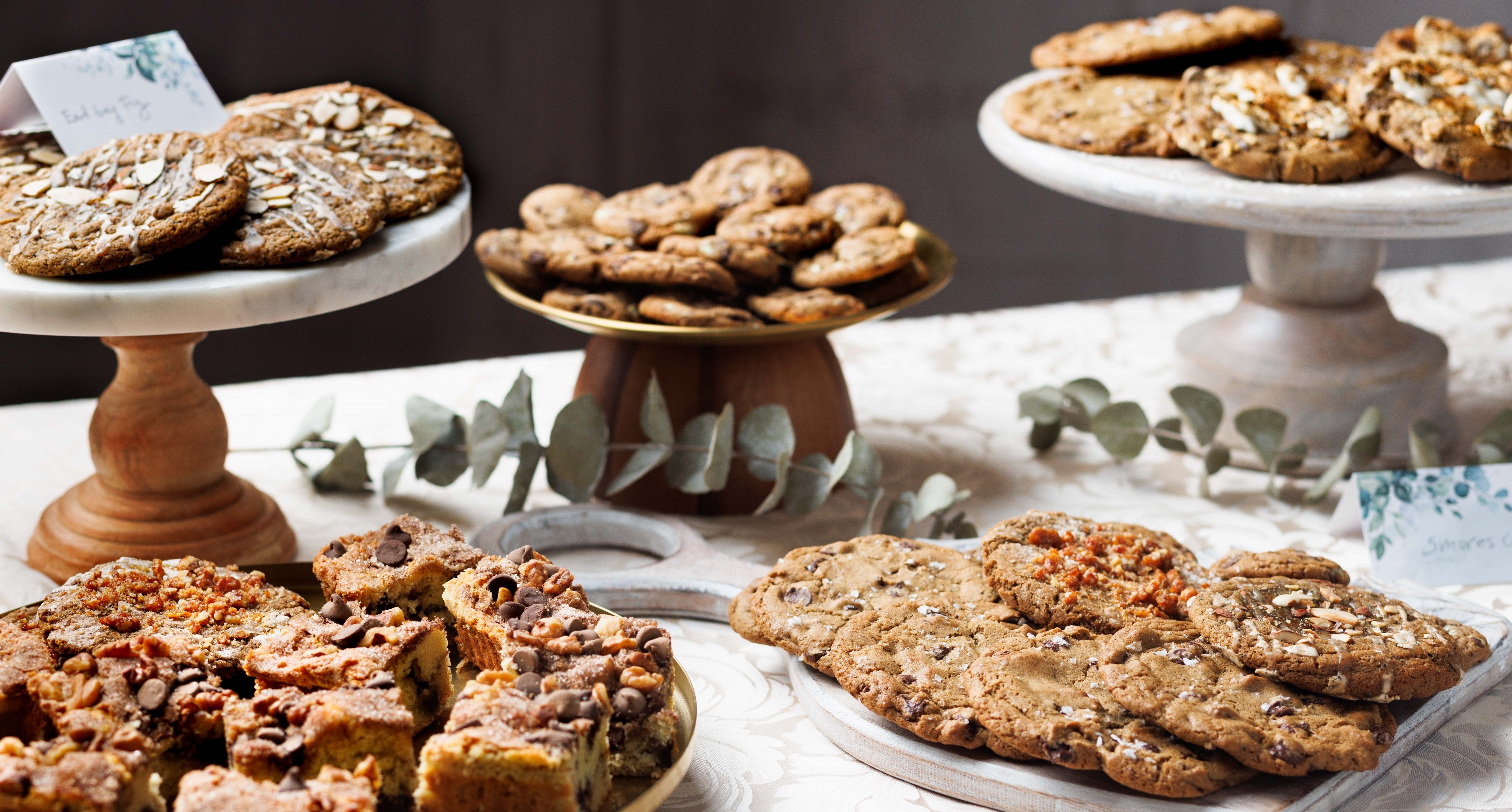 a catering display with mini salted brown butter chocolate chip cookies, sour cream coffee cake, and assorted other gourmet cookies chef crafted cookies.  Gooey cookies, chewy cookies, best cookies in san diego, best cookies near me, best bakery near me, these mini chocolate chip cookies are great for catering, events, corporate gifts, corporate catering, corporate orders, nationwide shipping, cookie delivery, cookie box shipping,  best chocolate chip cookies, best bakery san diego, best cookies san diego