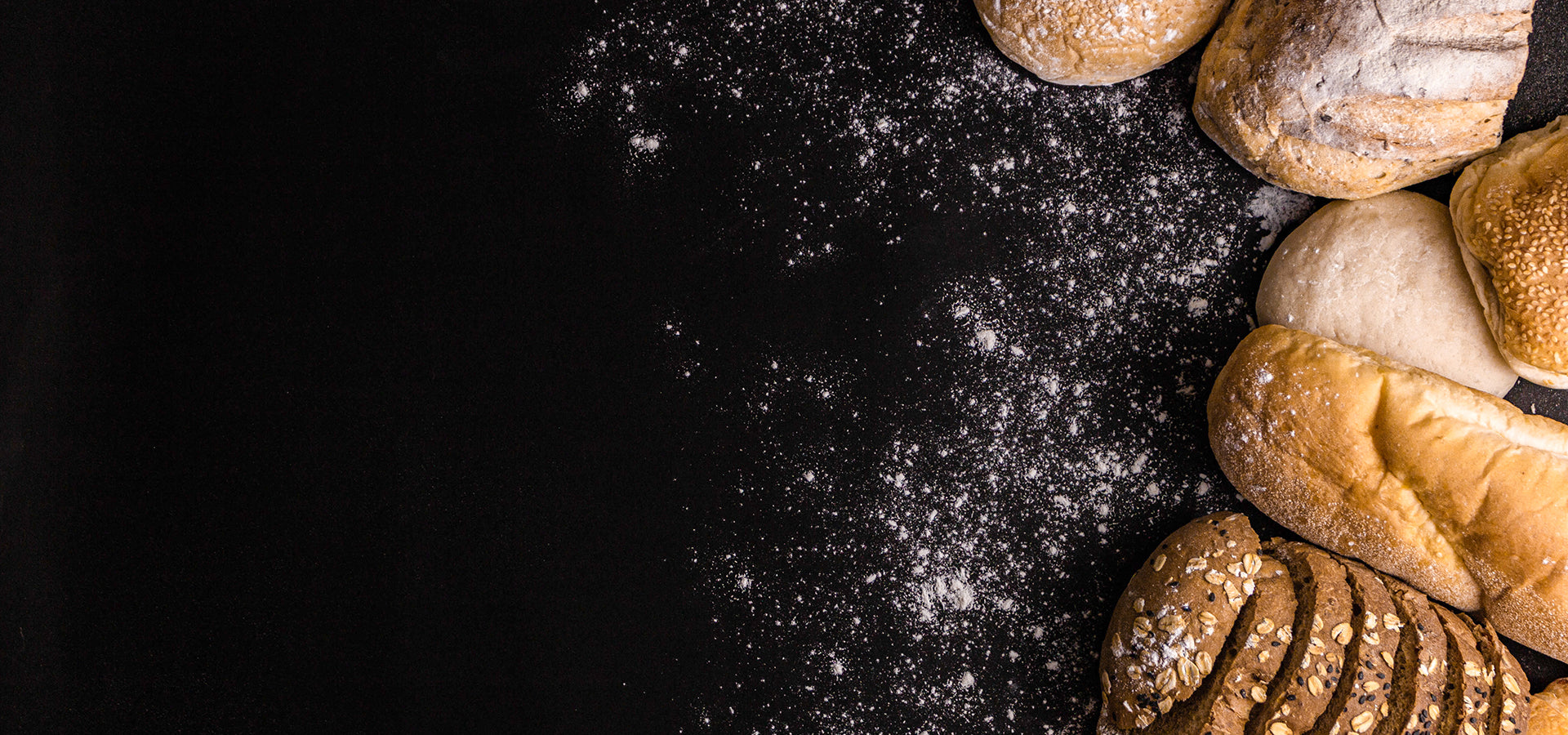 bread-concept-several-slices-dark-brown-bread-with-seeds-buns-croissants-loaves-bread-gathered-together-black-background-with-sprinkling-flour-dust.jpg